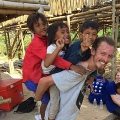 Kyle Heser with kids in Cambodia