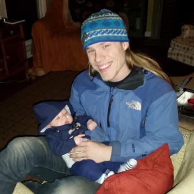 Riley Armstrong holding a baby
